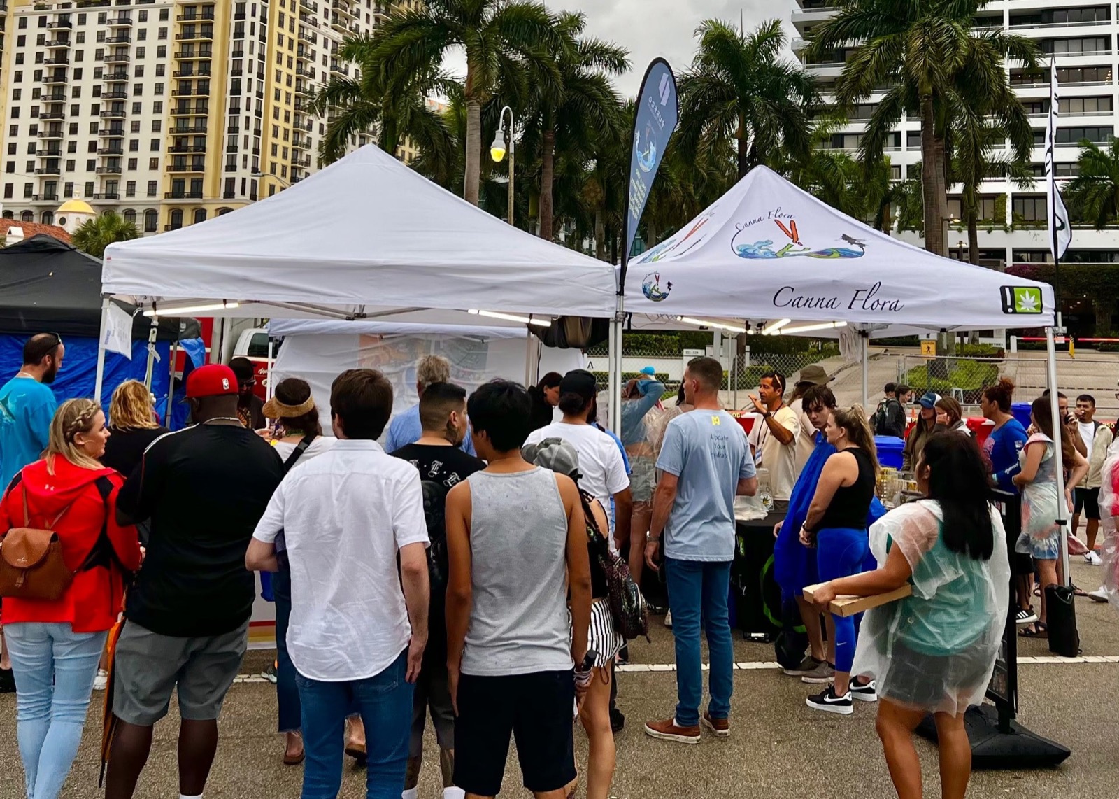 Canna Flora's tent at a Jupiter waterfront community event, with a crowd gathered around